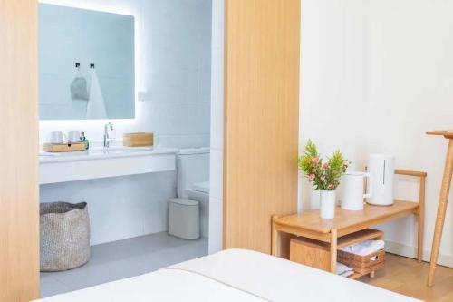 a bathroom with a sink and a toilet and a mirror at TRANQUIL HOUSE in Lhasa