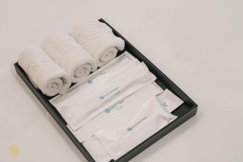 a suitcase filled with towels and papers on a table at San Hotel & Spa in Hanoi