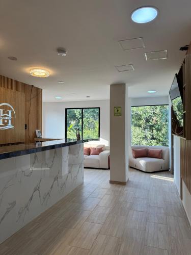 a kitchen and living room with a counter top at Hotel Bello Horizonte in Santa Marta