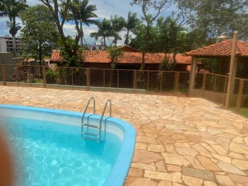 a swimming pool in a yard with a fence at Villa Domus in Barretos