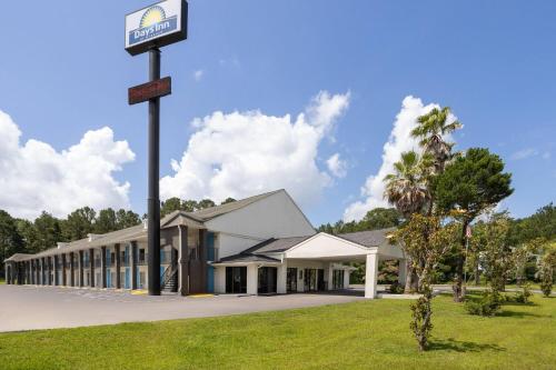 a building with a street sign on a pole at Days Inn by Wyndham Hardeeville Near Hilton Head in Hardeeville