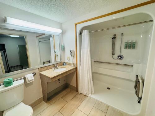 a bathroom with a shower and a toilet and a sink at Best Western Sault Ste. Marie in Sault Ste. Marie