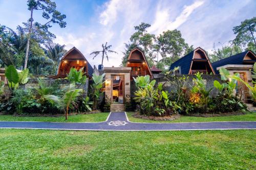 a house in the middle of a garden with a driveway at Jungle Forest Villa Ubud by The Travel Ubud Bali in Ubud