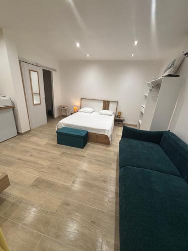a large bedroom with a bed and a couch at Bungalow BAO in Fort-de-France