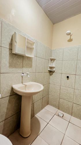 a bathroom with a sink and a shower at Chalés São Domingos in Barreirinhas