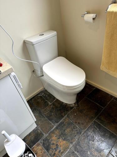 a bathroom with a white toilet in a room at Absolute beach front stunning views day and night in Cape Bridgewater