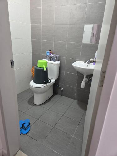 a small bathroom with a toilet and a sink at D'BROGA HILL Homestay in Kampong Solok