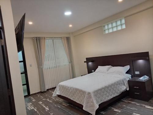 a bedroom with a large bed and a window at RoofTop in Kollpa