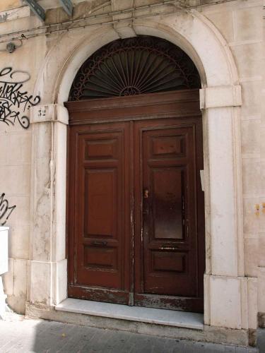 a large wooden door on the side of a building at Luciano And Son in Campobasso