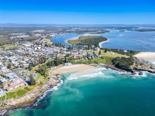 an aerial view of a beach and the ocean at Flinders Lodge in Yamba