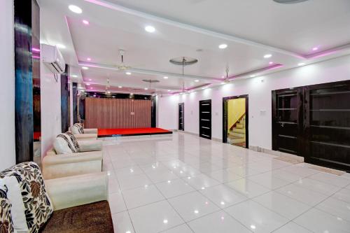 a lobby with a couch and a conference room at Hotel O Magadh Guest House in Gaya