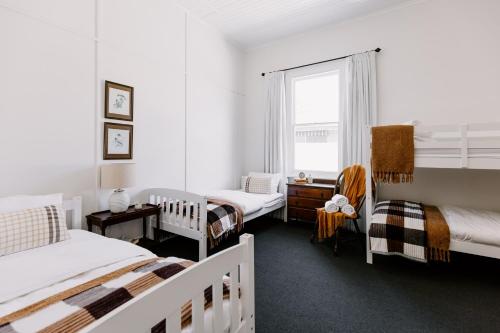 a bedroom with two beds and a window at Oakview Country House Maffra in Maffra