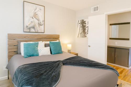 a bedroom with a large bed with blue pillows at ᨒོ The Good Life - Fun Pool Escape 15 min to Strip in Las Vegas