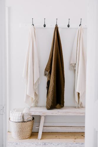a bench with towels hanging on a wall at Oakview Country House Maffra in Maffra