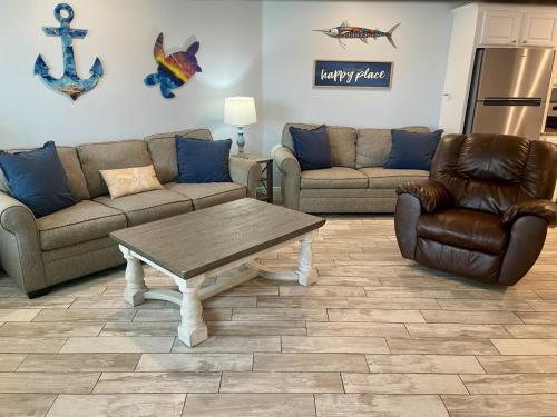 a living room with two couches and a coffee table at Beachgate Condo Suites and Hotel 514 condo in Port Aransas