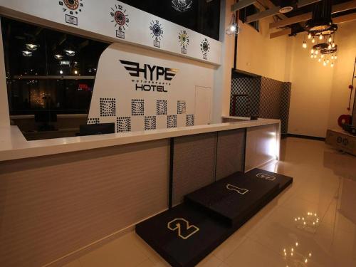 a restaurant with a counter with a hotel sign at Arafah Hotel Nilai in Kampong Tanjong