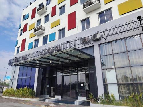 a building with colorful squares on the side of it at Arafah Hotel Nilai in Kampong Tanjong