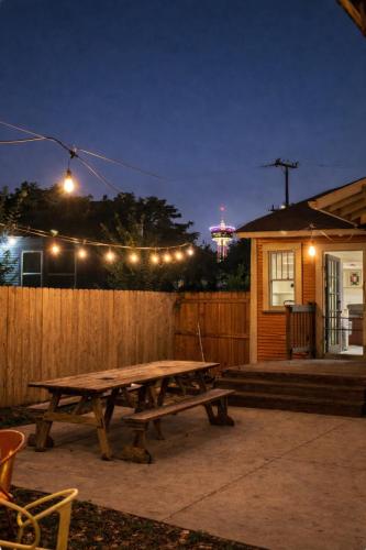 a picnic table in front of a fence at night at Location! Downtown San Antonio, Southtown, King William in San Antonio