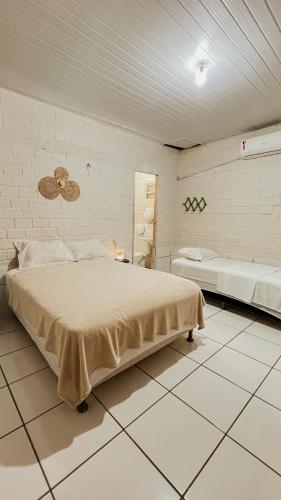 a bedroom with a large bed in a room at Chalés São Domingos in Barreirinhas