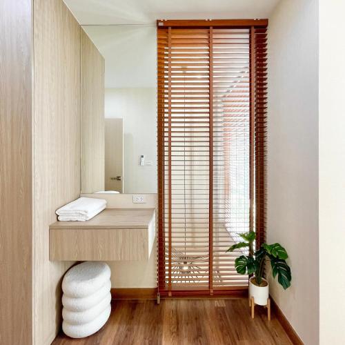 a bathroom with a sink and a mirror at Swan Private Pool Villa Bangsaen in Ban Thai Don (1)