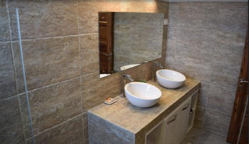 a bathroom with two sinks and a mirror at Mountain View Apartment in La Gaulette