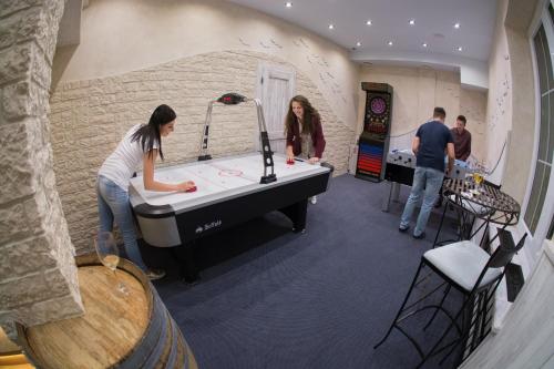 a group of people in a room with a pool table at Penzion Na Palubě in Jeseník