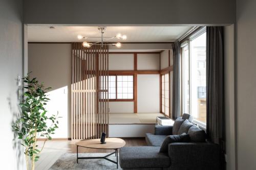 a living room with two couches and a table at 禅ーZen Villa Hakodate in Hakodate
