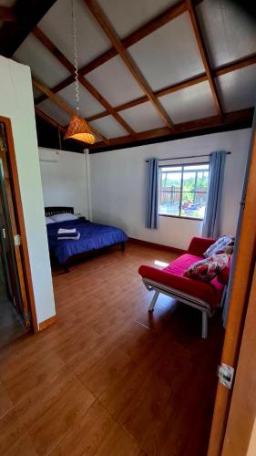 a living room with a bed and a couch at Anna Garden Homestay in Ban Phlu Kom