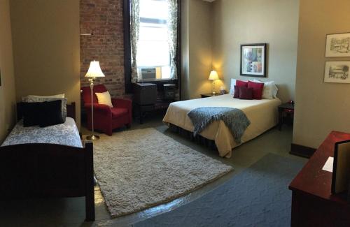 a hotel room with a bed and a chair at Morguen Toole in Meyersdale