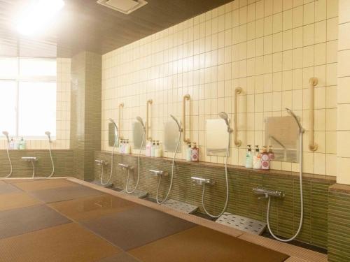 a bathroom with a row of sinks and mirrors at Nagasaki Sky Hotel in Nagasaki