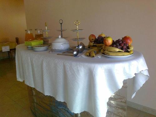 a table with a bunch of fruit on it at Villa Paradiso in Wrocław