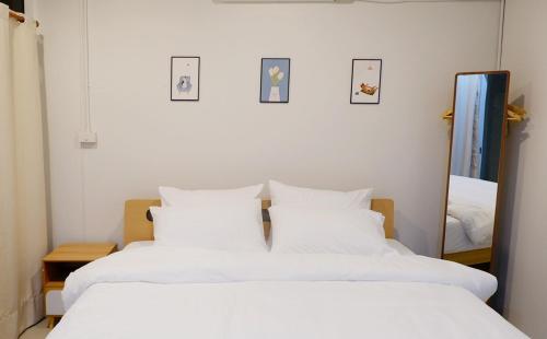 a bedroom with two white beds and a mirror at Stay Together 3BR walkable to Nimman 6 Guests in Chiang Mai