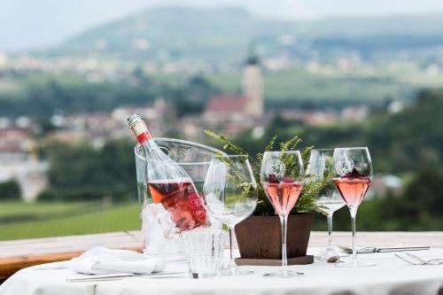 a group of wine glasses sitting on a table at Schloss Hotel Korb in Appiano sulla Strada del Vino