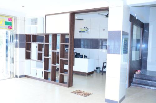 a lobby of a building with a large glass door at ARS INN AND MINI HALL Vellore in Vellore