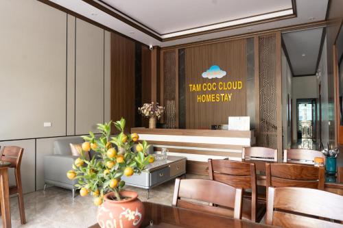 a restaurant with a table and chairs and a counter at Tamcoc Cloud Homestay in Ninh Binh