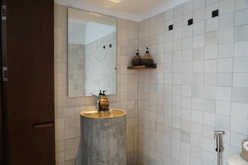 a bathroom with a sink and a mirror at The Still Slow & Sip in Nha Trang
