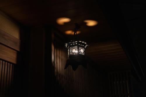 a chandelier hanging from a ceiling in a dark room at Boutique Stay Kanazawa Oost Knoll in Kanazawa