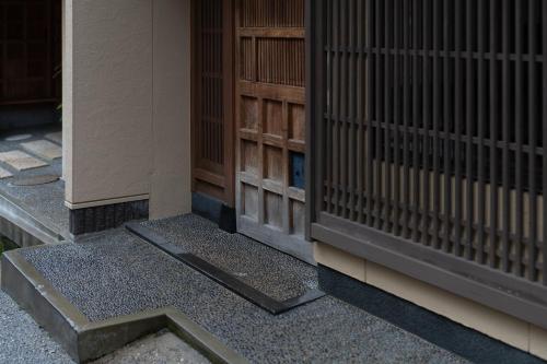 a corner of a building with a door and a stairway at Boutique Stay Kanazawa Oost Knoll in Kanazawa