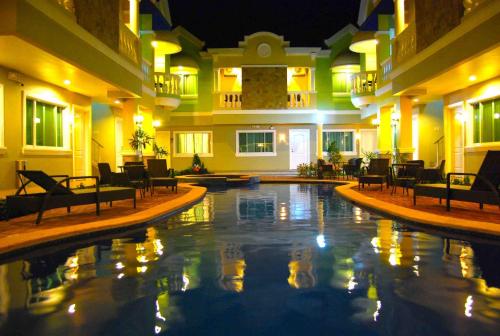 a large swimming pool in a hotel at night at Prism Hotel in Angeles