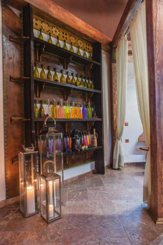 a room with a shelf filled with colorful glass bottles at LETIZIA country club in Shaian