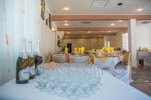 a group of wine glasses sitting on a table at Pensiunea Tinelu Brașov sacele in Braşov