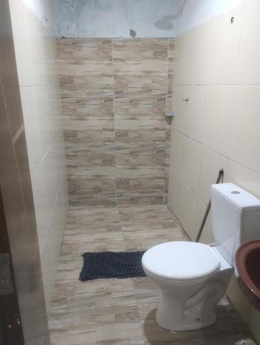 a bathroom with a toilet and a shower at 3-bedroom house on Cabuçu beach in Saubara
