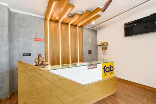 a lobby with a reception desk with a counter at FabHotel Lake View Castle in Warangal