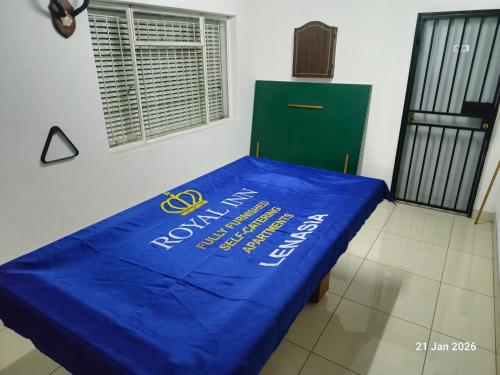 a bed with a blue tarp on it in a room at Royal Inn - Fully Furnished Self-Catering Apartments in Lenasia