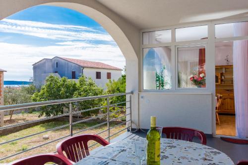 a balcony with a table and chairs and a window at Apartments Duje in Trogir