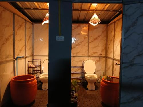 a bathroom with two toilets in a room at Kalaland in Patong Beach