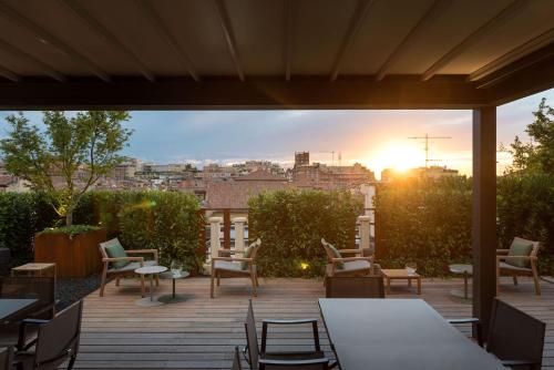 a patio area with a table and chairs at Hotel Metropolitan in Bologna
