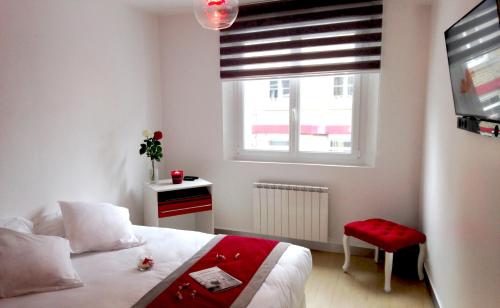 a small bedroom with a bed and a window at APPART'HOTEL61 in Flers