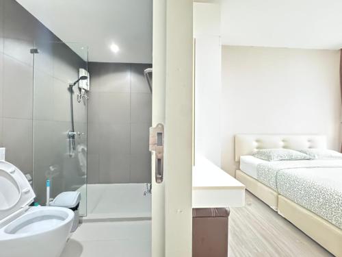 a bathroom with a shower and a bed and a sink at Ekkamai Bangkok Condo in Bangkok