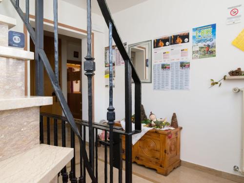 a staircase with black railings in a house at Haus Elisabeth in Nova Ponente